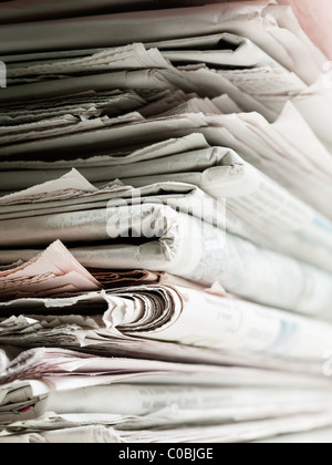 Old newspaper stacked in pile for recycling. Studio shot with selective focus and copy space Stock Photo