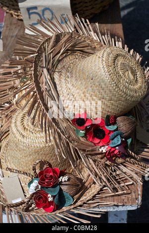 Tattered Straw hat and embellishments for sale on a Thai stall. Thailand S. E. Asia Stock Photo