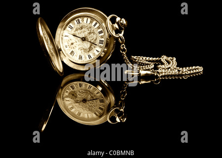 old pocket watch on black background with reflection Stock Photo