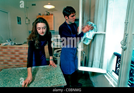 Paris, France, Young Teenage Couple Sharing Housework at Home, in Studio Apartment. Authentic French lifestyle Paris, France, Young Teenage Couple Sharing Housework at Home, in Studio Apartment. Authentic French lifestyle