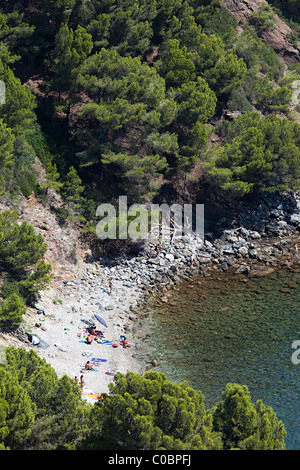 People on secluded beach on Mediterranean coast Cala Rostella Parc Natural de Cap de Creus Emporda Catalunya Spain Stock Photo