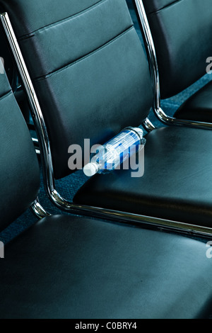 Abstract image of an abandoned water bottle in an airport lounge Stock Photo