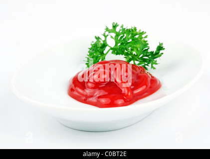 Small bowl of red tomato sauce on white background Stock Photo