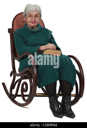 Image of an old woman sitting on a rocker with a closed book in her lap. Stock Photo