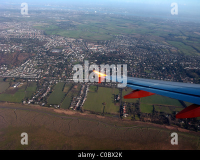 easyjet a319 airbus aircraft wing looking out through aircraft window over the wirral coastline merseyside Stock Photo