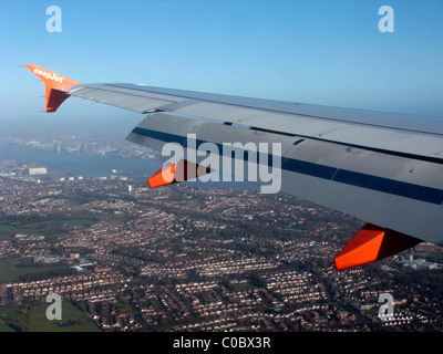 easyjet a319 airbus aircraft wing looking out through aircraft window down at birkenhead and liverpool