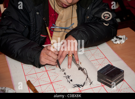 Paris, France - February 12, 2011 -  A man demonstrating demonstrating chinese calligraphy Stock Photo