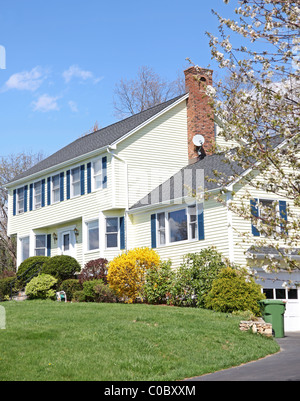 Yellow New England Style colonial house on a spring day Stock Photo