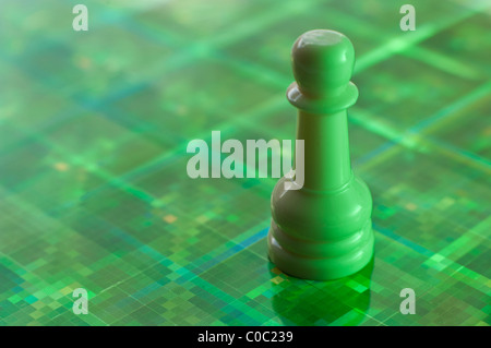 Lone chess pawn in green coloring Stock Photo