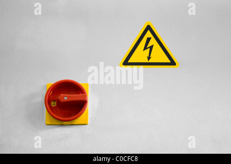 Main switch and a sign of dangerous voltage Stock Photo