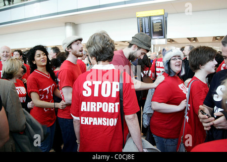 A large group of protesters of all ages wearing red t-shirts with the slogan 'Stop Airport Expansion' converge on Heathrow to Stock Photo