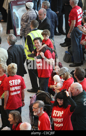 A large group of protesters of all ages wearing red t-shirts with the slogan 'Stop Airport Expansion' converge on Heathrow to Stock Photo