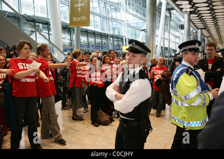 A large group of protesters of all ages wearing red t-shirts with the slogan 'Stop Airport Expansion' converge on Heathrow to Stock Photo