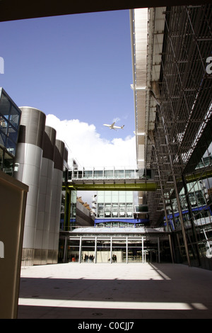 The exterior of Terminal 5 A large group of protesters of all ages wearing red t-shirts with the slogan 'Stop Airport Stock Photo