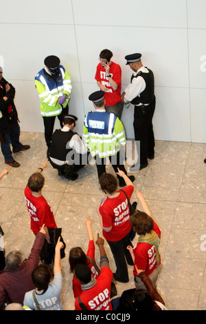 A large group of protesters of all ages wearing red t-shirts with the slogan 'Stop Airport Expansion' converge on Heathrow to Stock Photo