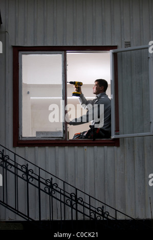 Man doing home improvement using power drill Stock Photo