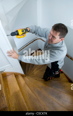 Man doing home improvement using power drill Stock Photo