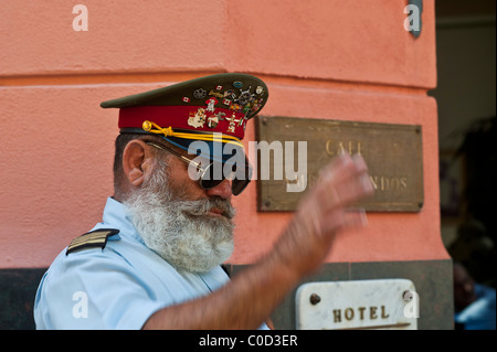 Cuban man posing as Ernest Hemingway with a cigar and cap. Old Havana, Cuba Stock Photo