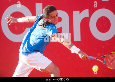 Spanish tennis player Nicolas Almagro is stretching to hit a backhand shot during ATP Buenos Aires - Copa Claro 2011 Stock Photo