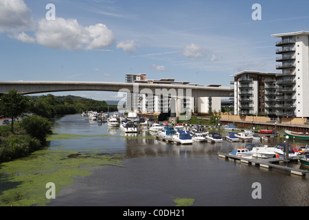 Boats moored in the Ely River in Cardiff Bay Wales UK Riverside housing apartments Stock Photo