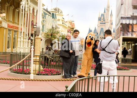 A family poses for the Disney World photographer in the Main Street square at  Disney World's Magic Kingdom in Orlando, Florida. Stock Photo