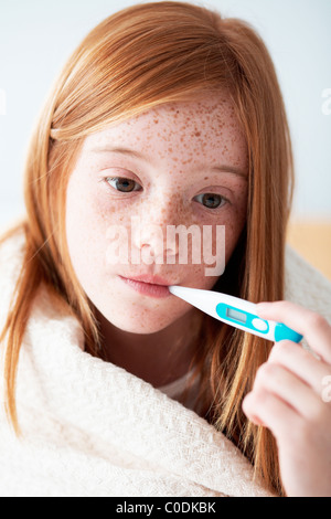 Girl checking her temperature Stock Photo