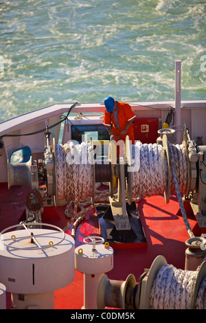 A deckhand on a North Sea ferry at work Stock Photo