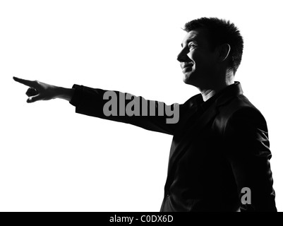 silhouette caucasian business man expressing pointing mocking sneering behavior full length on studio isolated white background Stock Photo