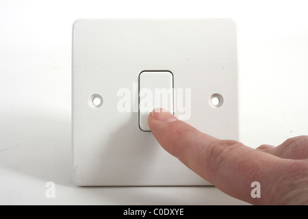 Pressing a light switch Stock Photo