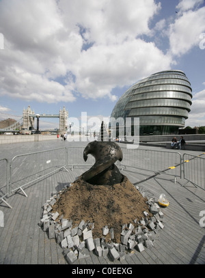A Giant Drill Bit surfaces through the paving stones on the walkway at the foot of Tower bridge as part of an art installation Stock Photo