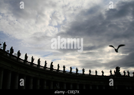 statues on top of colonnade at st peter's square in rome Stock Photo