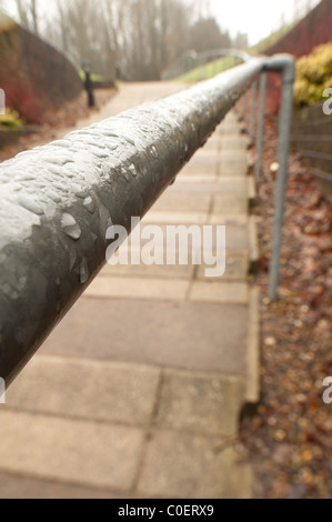hand rail coated with rain droplets Stock Photo