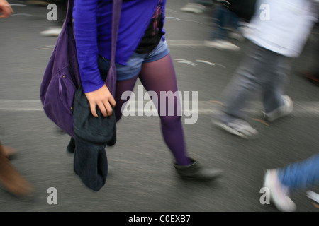 young woman with purple socks tights feet legs walking  in street in town Stock Photo
