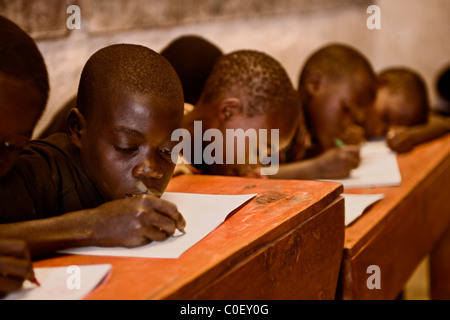 Boys work at their desks in a Rwandan school house. Stock Photo