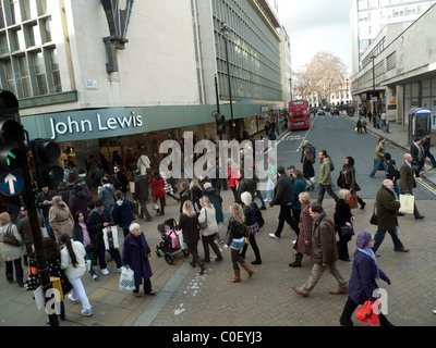 High street shoppers and pedestrians walking outside the entrance of John Lewis department store on Oxford Street in London, England UK    KATHY DEWITT Stock Photo