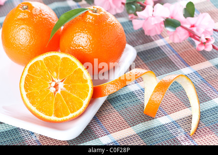 Ripe fresh orange tangerines on white shaped plate Stock Photo