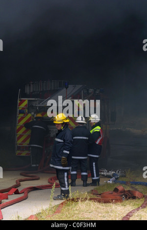 Firemen at scene of a farm fire in Essex Stock Photo