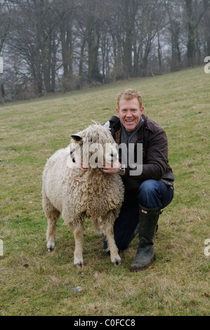 Adam Henson Cotswold farmer with his rare breeds sheep on Adam's farm at Temple Guiting Gloucestershire UK Stock Photo