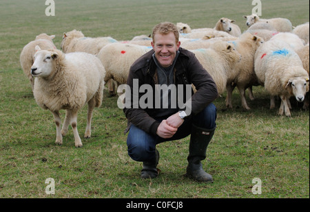 Adam Henson Cotswold farmer with his rare breeds sheep on Adam's farm at Temple Guiting Gloucestershire UK Stock Photo