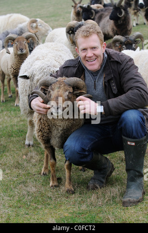 Adam Henson Cotswold farmer with his rare breeds sheep on Adam's farm at Temple Guiting Gloucestershire UK Stock Photo