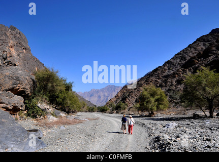 Wadi Bani Kharus Oman, two tourists walking, Oman. Stock Photo