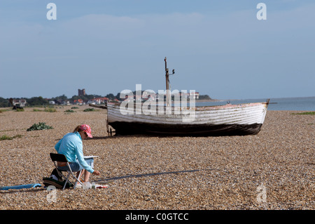 Artist painting beach scene, Aldeburgh, Suffolk, UK. Stock Photo