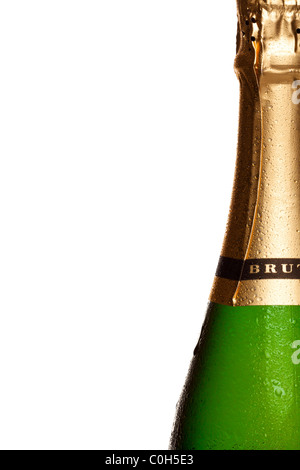 Close up photo of champagne bottle covered in water droplets, on right side of frame with white background. Stock Photo