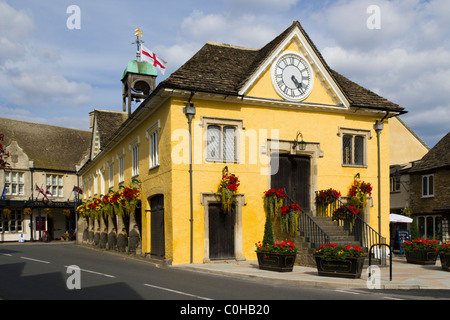 Colourful summer flowers decorate the historic old Cotswold Market Hall in Tetbury, Gloucestershire, UK Stock Photo