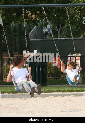 Chris Cornell and his daughter Toni playing on the swings as the musician spent some quality time with his two young children Stock Photo