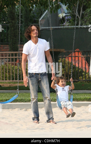 Chris Cornell and his daughter Toni playing on the swings as the musician spent some quality time with his two young children Stock Photo