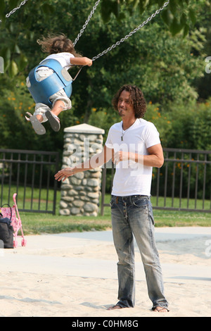 Chris Cornell and his daughter Toni playing on the swings as the musician spent some quality time with his two young children Stock Photo