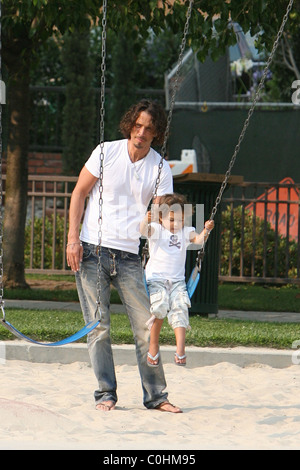 Chris Cornell and his daughter Toni playing on the swings as the musician spent some quality time with his two young children Stock Photo