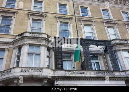 London Metropolitan police officers guard the outside of the London Libyan embassy that still flies the pro-Gadaffi flag. Stock Photo