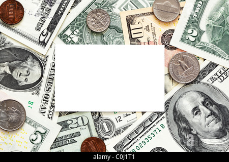 Blank business card with US dollar bills and coins as a background Stock Photo